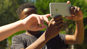 Children using ArcGIS Hub on mobile in Johns Creek, GA