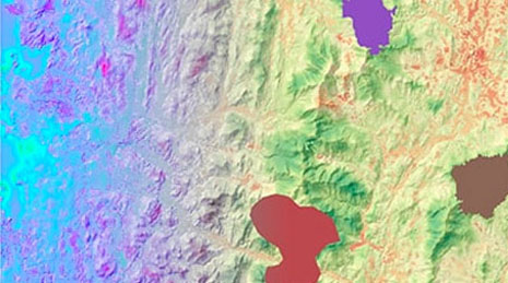 Multicolored topographic map of land with yellow, green, and blue colors