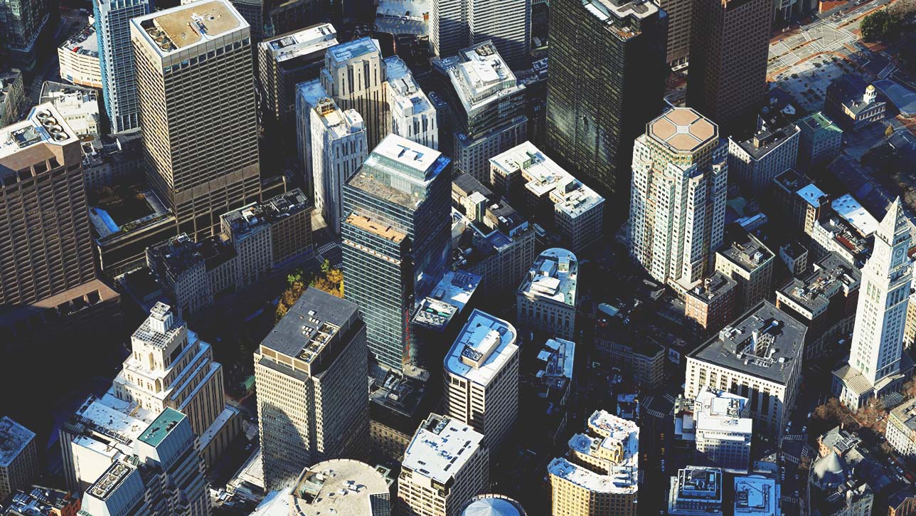 An image of a city with a group of short and tall buildings representing a textured 3D mesh 