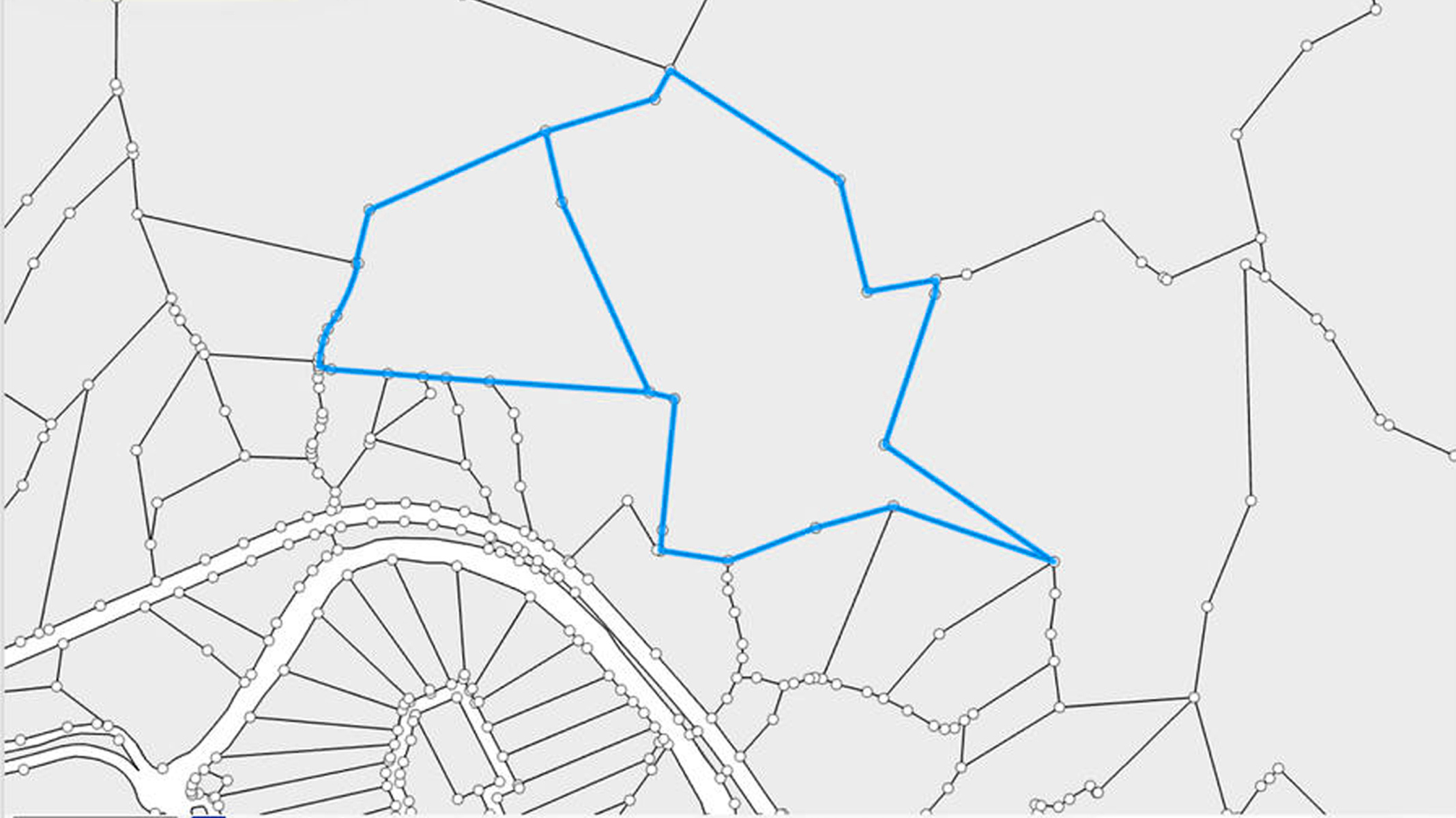 Um mapa com uma rede de linhas e nós, com um polígono grande e irregular destacado em azul.